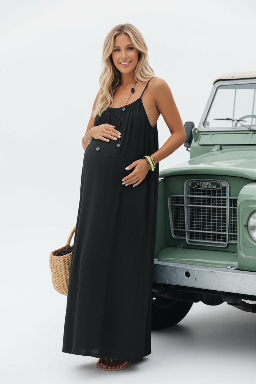 Pregnant model in black spaghetti dress with car - portrait